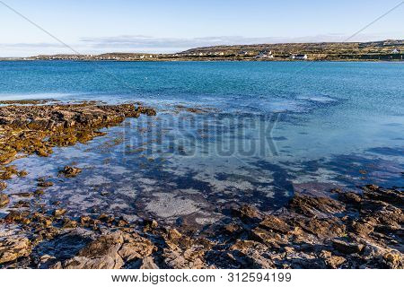 Beach In Kilronan With Houses In  Background