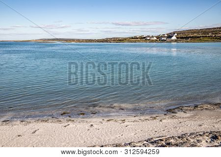 Beach In Kilronan With Houses In  Background