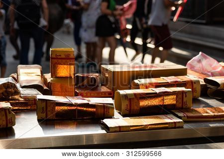 Yunlin, Taiwan - July 13th, 2019: chinese joss gold paper craft on a table at Beigang Chaotian Temple, Yunlin, Taiwan, Asia