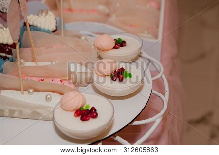 Panakota On The Wedding Table. Gentle White Wedding Cake And Different Sweets On Table.