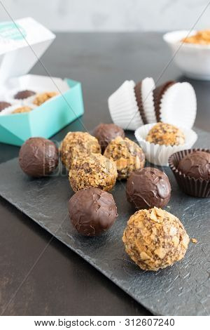 Wrapping Chocolate Truffles In Icing And Wafer Crumbs In Gift Boxes