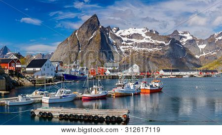 Hamnoy Village on the Lofoten Islands, Reinefjord,  Norway. Panoramic Shot,  Fishing boats in harbor on Lofoten Islands,  Norway - Mountain In Background