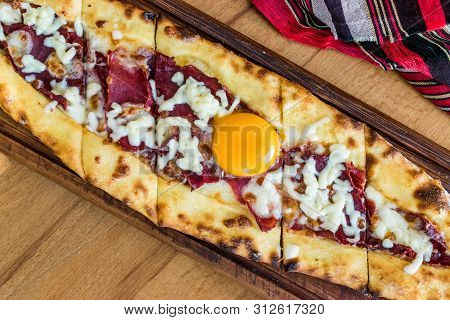 Traditional Turkish Pide At Kebab Restaurant On Wooden Table.