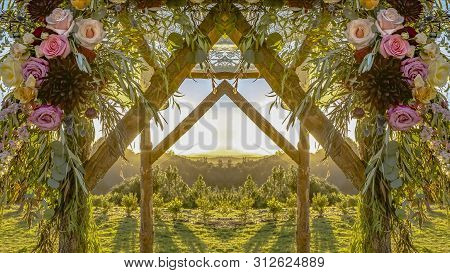 Chuppah At Sunsset With Flowers In Circular Arrangement At Wedding In California