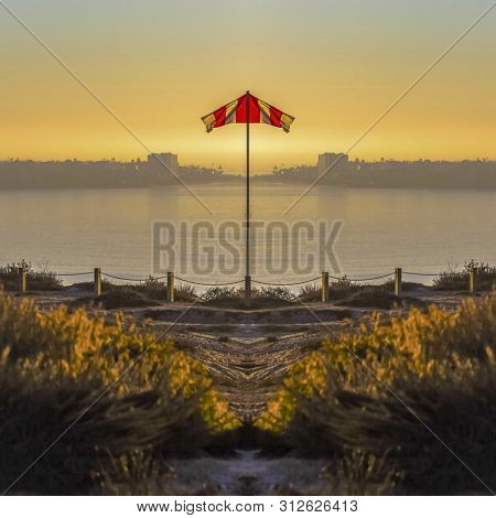 Imgae Of A Reflected Flag On The Shore Of San Diego With Sunset On A Clear Day