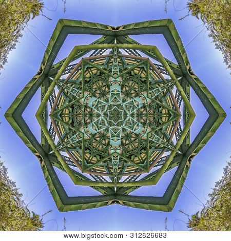 Star Shape With Steel Girders That Are Painted Green With Blue Sky