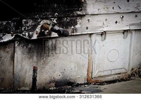 Gas Pipe And Coal Chute On The Side Of A House After A House Fire.