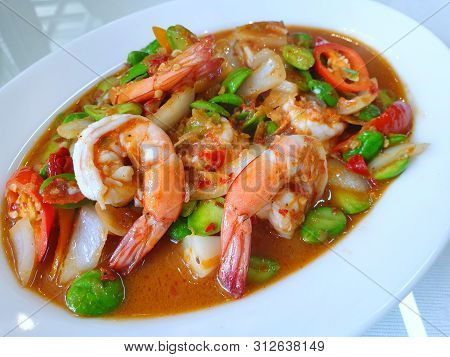Thai Food Style, Selective Focus Of Spicy Fried Shrimp With Stink Bean Isolated On White Background,