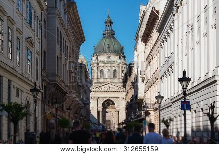 Crowded Tourist At Zrinyi Utca Street With Saint Stephen`s Basilica In Budapest, Hungary