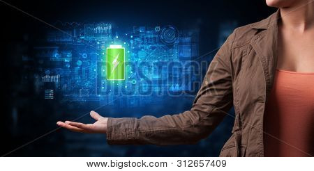 Elegant hand holding battery with full of energy