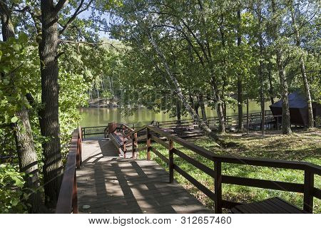 Well-maintained Pedestrian Walkway To The Shore Of The Pond. Sunny Day In September. Landscape Reser