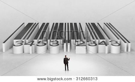 Young businessman standing in front of a big codebar