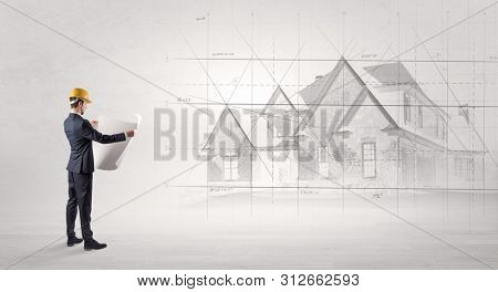 Architect standing and watching an imagined house plan