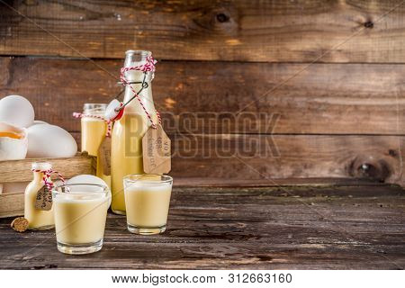 Traditional Italian Vov Eggs Liquor. German Egg Liqueur Eierlikor. In Different Bottle And Shot Glas