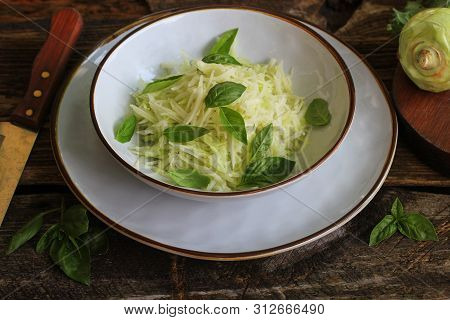 Fresh Salad With Kohlrabi, Parmesan, Basil And Sesame Dresing In A Bowl. Vegetarian Food