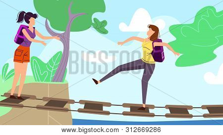 Young Women Walking Along Staggering Suspension Bridge In Forest Or Park. Summer Time Vacation, Trip