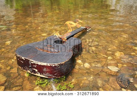Dogara Old Acoustic Guitar Floats On The Water. Incendiary Music, The Crisis Of The Genre, The End O