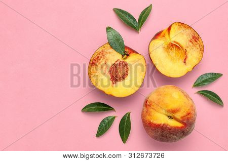 Flat Lay Composition With Peaches. Ripe Juicy Peaches With Green Leaves On Pink Background. Flat Lay