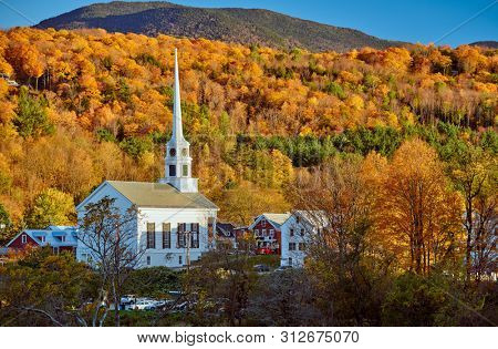 Iconic New England church in Stowe town at autumn in Vermont, USA 