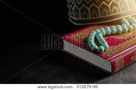 The Holy Quran With Rosary Beads And Kopiah Hat For Muslims