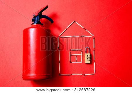 Fire Safety, Or Security And Protection Concept. A Fire Extinguisher, The Figure Of The House And Lo