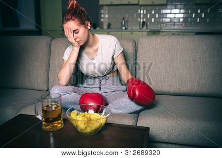 Young Woman Watch Boxing On Tv At Night. Confused Upset And Unhappy Model Hold Hand On Face. Alone I