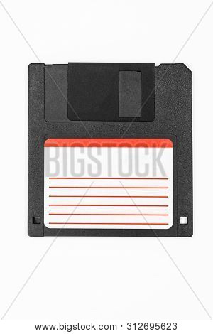 Black Floppy Disk With White Information Sticker With Red Lines With Copy Space On White Background