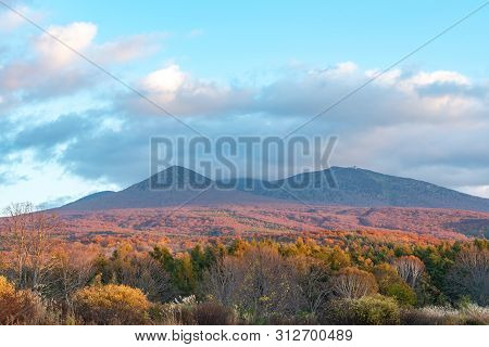 Autumn Foliage Scenery In Kayano-kogen Plateau, Aomori, Japan. Hakkoda Mountains On Background Bathe