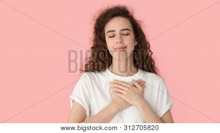 Grateful Woman Touch Heart With Hands Isolated On Pink Background