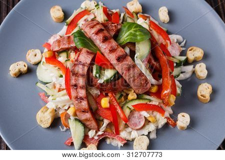 Salad With Grilled Sausage Paprica Cucumber And Croutons