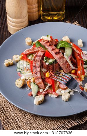 Salad With Grilled Sausage Paprica Cucumber And Croutons