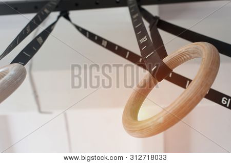 Two Wooden Rings For Sports On The Crossbar On The Slings. Concept Of Sports With Its Own Weight In 