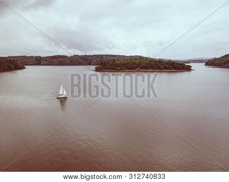 Summer Leaisure Activity, Yacht In The Middle Of Orlik Lake. Cloudy Evening Sky
