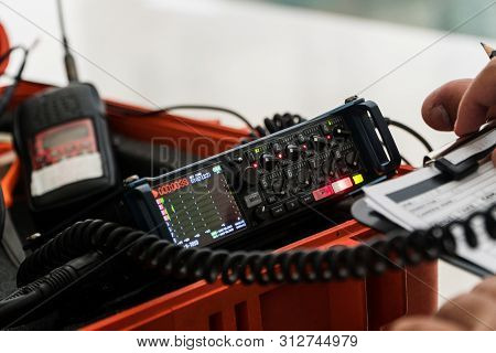 Multitrack Field Recorder With Equipment Of Filmmaking. Sound Engineer Is Recording Sound And Take A