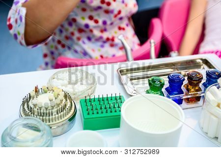 Set Of Dentist Tools And Equipment On Clinic Desktop