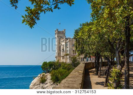 Miramare Castle Building Above Adriatic Sea. The View Of Beautiful Miramare Castle Located Close To 