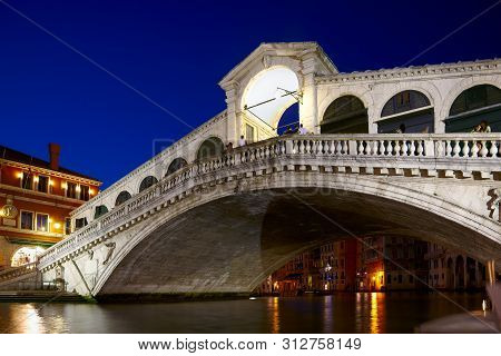 Night Shot Of Rialto Bridge ( Ponte Rialto ) On Canal Grande In Venice, Veneto, Italy