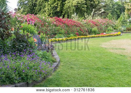A View Of A Lawn And Flower Garden At Point Defiance Park In Tacoma, Washington.