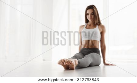 Professional Contemp Dancer Sitting And Pointing Toes In Dance Class. Panorama, Free Space, Selectiv