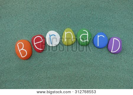 Bernard, Masculine Given Name Composed With Multi Colored Stones Over Green Sand