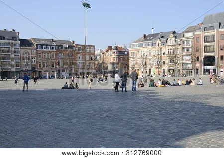 Leuven, Belgium - April 1, 2019: People At The Big Square Where Is Located A Giant Shiny Green Beetl
