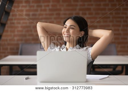 Relaxed Smiling Asian Businesswoman Take Break To Rest At Workplace