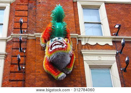 Chinese Lion Or Colorful Dragon On The Red Brick Wall At Chinatown In Soho Central London For The Ne