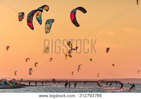 Anapa, Russia - Sebtember 9, 2017: Kitesurfer Ride Kites On Flat Surface Of Bugaz Firth At Black Sea