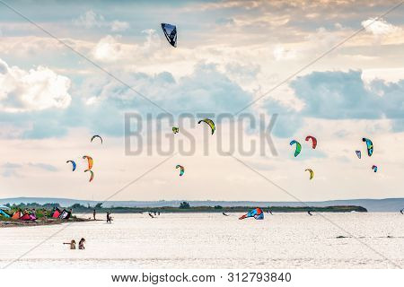 Anapa, Russia - July 9, 2017: Man Kitesurfer Rides Kite Splashing On Flat Surface Of Bugaz Firth At 