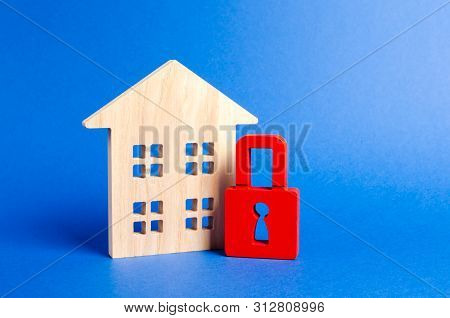 Wooden House And A Red Padlock. Security And Safety. Confiscation For Debts. Alarm System. Seizure O