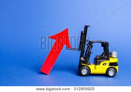 A Yellow Forklift Raises A Big Red Arrow Up. Growth In Production Rates And Development Of Industry 