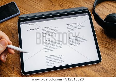 Paris, France - Jun 6, 2019: Man Reading On Apple Ipad Pro Tablet About Latest Announcement Of At Ap