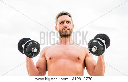 Dare To Be Great. Muscular Man Exercising With Dumbbell. Dumbbell Exercise. Sportsman Strong Biceps 