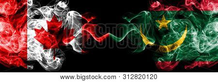 Canada Vs Mauritania, Mauritanian Smoky Mystic Flags Placed Side By Side. Thick Colored Silky Smoke 